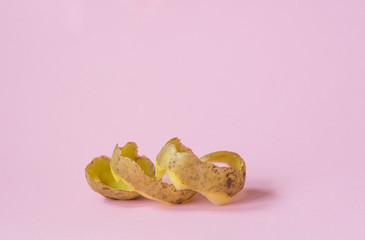 potato peel on pink background as a symbol of recycling circulate economy