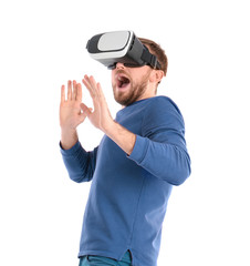 Emotional man with virtual reality headset on white background