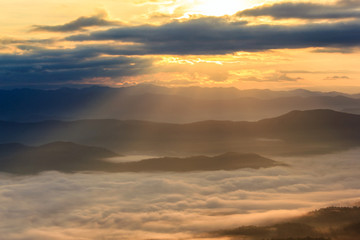 Fototapeta na wymiar Sunbeam in the mountains and mist at at Doi Samer Dao, Nan Province, Thailand