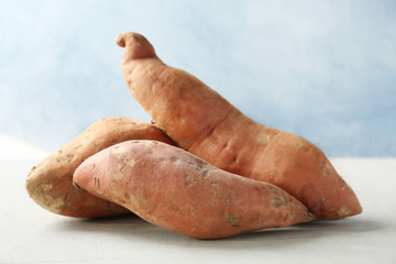 Sweet potatoes on light background