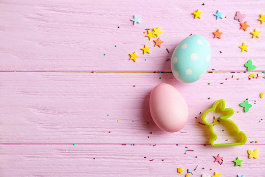 Bunny Shaped Cookie Cutter And Easter Eggs On Color Background