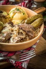 Fried chicken liver with onion served with mashed potatoes and pickled cucumber.