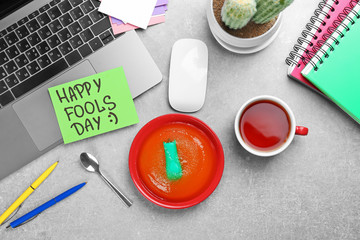 Plate with jelly and stapler on office table. April fool's day celebration