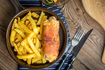 Fried chicken breast stuffed with mushrooms and cheese wrapped in ham served with fries and salad.