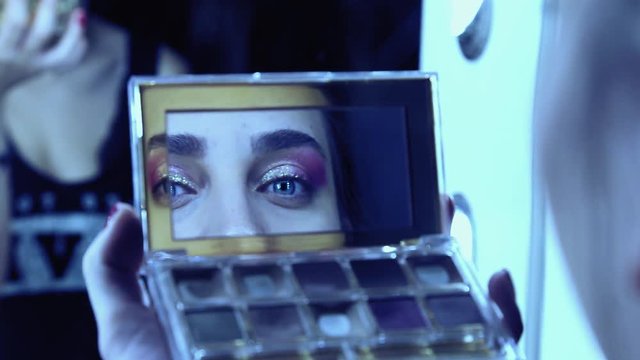 Beautiful model look through the mirror