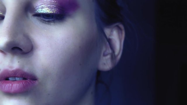 Use makeup on a beautiful woman in slow motion