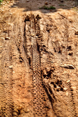 Bike tire tracks on muddy trail royalty. Tire tracks on wet muddy road, abstract background, texture material. Tyre track on dirt sand or mud, retro tone, grunge tone, drive on sand, off road track.