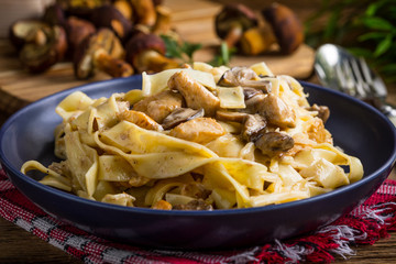 Tagliatelle pasta with forest mushrooms and chicken.
