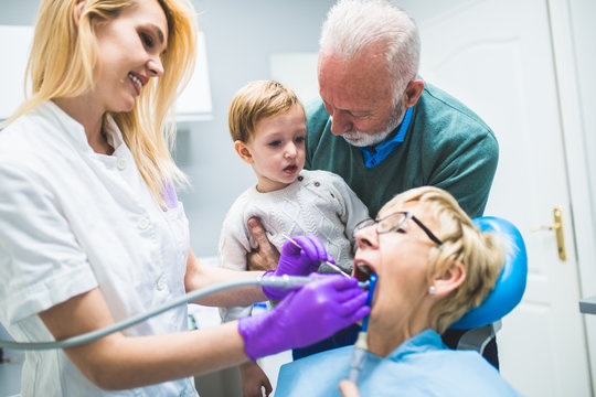 Two years old boy with his grandfather and grandmother first time in dental office
