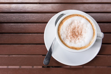 Cappuccino cup on wooden table, Top view
