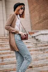 Beautiful young woman with a camera. warm colors. Street