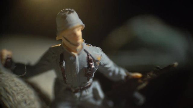 Miniature toy soldier with a gun in his hands
