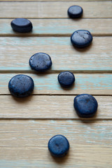 Blue decorative stones on a wooden background