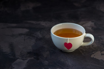 Cup of tea with heart shaped teabag tag