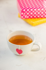 Cup of tea with heart teabag and gift boxes
