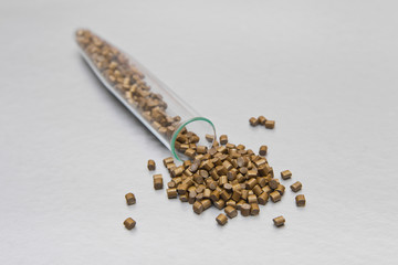 Plastic pallets . Colorant for polymers in granules. Golden mother of pearl granules of raw plastic...
