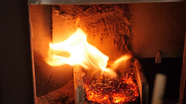 A dolly shot of pellet stove heating a room