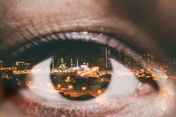 Double exposure of the female eye and Astana night city and mosque nur Astana in centre town