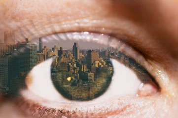 Double exposure of the female eye and Manhattan midtown. New York City