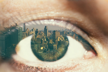 Double exposure of the female eye and Manhattan midtown. New York City