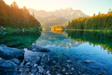 Fantastic sunrise on mountain lake Eibsee, located in the Bavaria, Germany. Dramatic unusual scene....