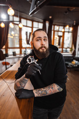 Portrait of professional creative tattoo master