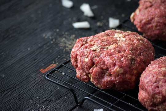 Raw Hamburger Patties With Onions And Herbs