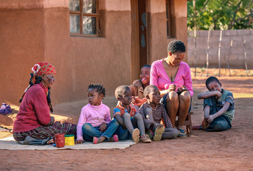 African family in front of the house