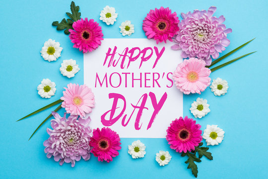 Happy Mother's Day Pastel Candy blue Colours Background. Floral flat lay minimalism greeting card.