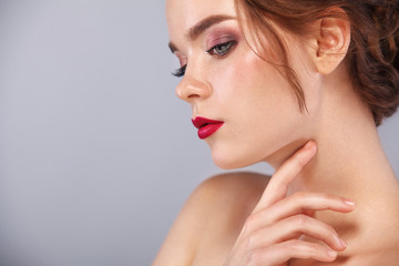 Closeup portrait of beautiful young woman with clean and fresh skin. Nude makeup. Model looking on...