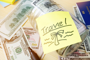 Savings for vacation concept. Jar with written word travel.