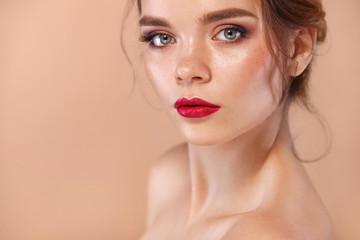 Closeup portrait of beautiful young woman model with clean and fresh skin. Nude makeup. Concept for cosmetology ads, beauty magazine and spa.