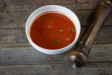 Tomato soup. On a wooden background. rustic food