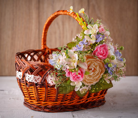 Fototapeta na wymiar Decorative Easter basket with flowers