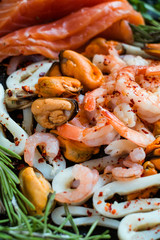 Seafood and salmon assortment on dark background. Omega 3 acid unsaturated fats. Healthy eating. Mediterranean cuisine concept