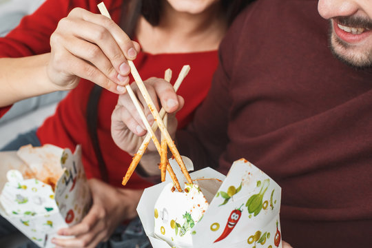 Young Couple Having Romantic Evening At Home Stealing Food