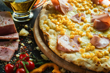 Delicious italian barbecue pizza with ham and corn. Fast food concept