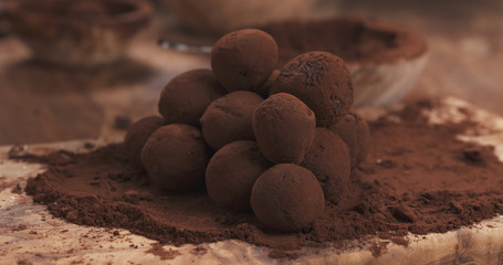 handmade truffles in cocoa powder on board