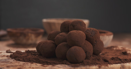sprinkling handmade truffles with cocoa powder