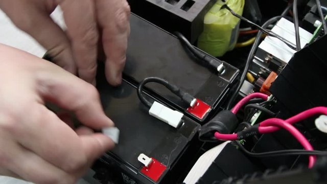 Connection of electric cables to uninterruptible Power Supply Battery.