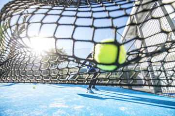 two women 47 years old playing Paddle tennis, Tennis ball at net