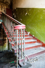 Ladder with a handrail in the old destroyed house
