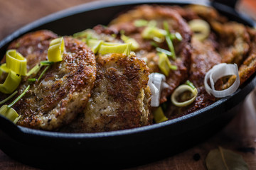 traditional hanukkah fried potato pancakes in black iron cast pan 