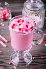 Pink hot chocolate with marshmallow and sugar hearts in a glass mug for Valentine Day