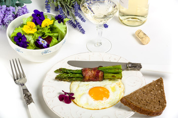 Egg with asparagus and bacon on a Mediterranean style