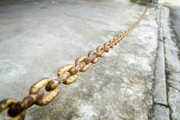 Part of a metal chain over gray background