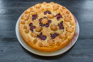 sand pie on a dark wooden background
