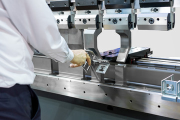 Operator working cut and bending metal sheet by high precision metal sheet bending machine, cnc control metal sheet bending machine