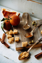 mulled wine in a mug and ingredients for making a drink on a white wooden background, top view