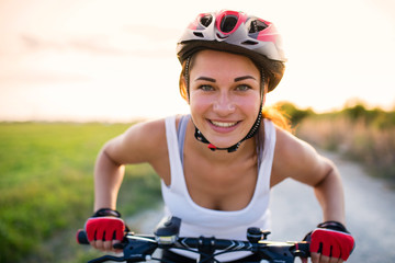 funny girl on a bicycle outside the city